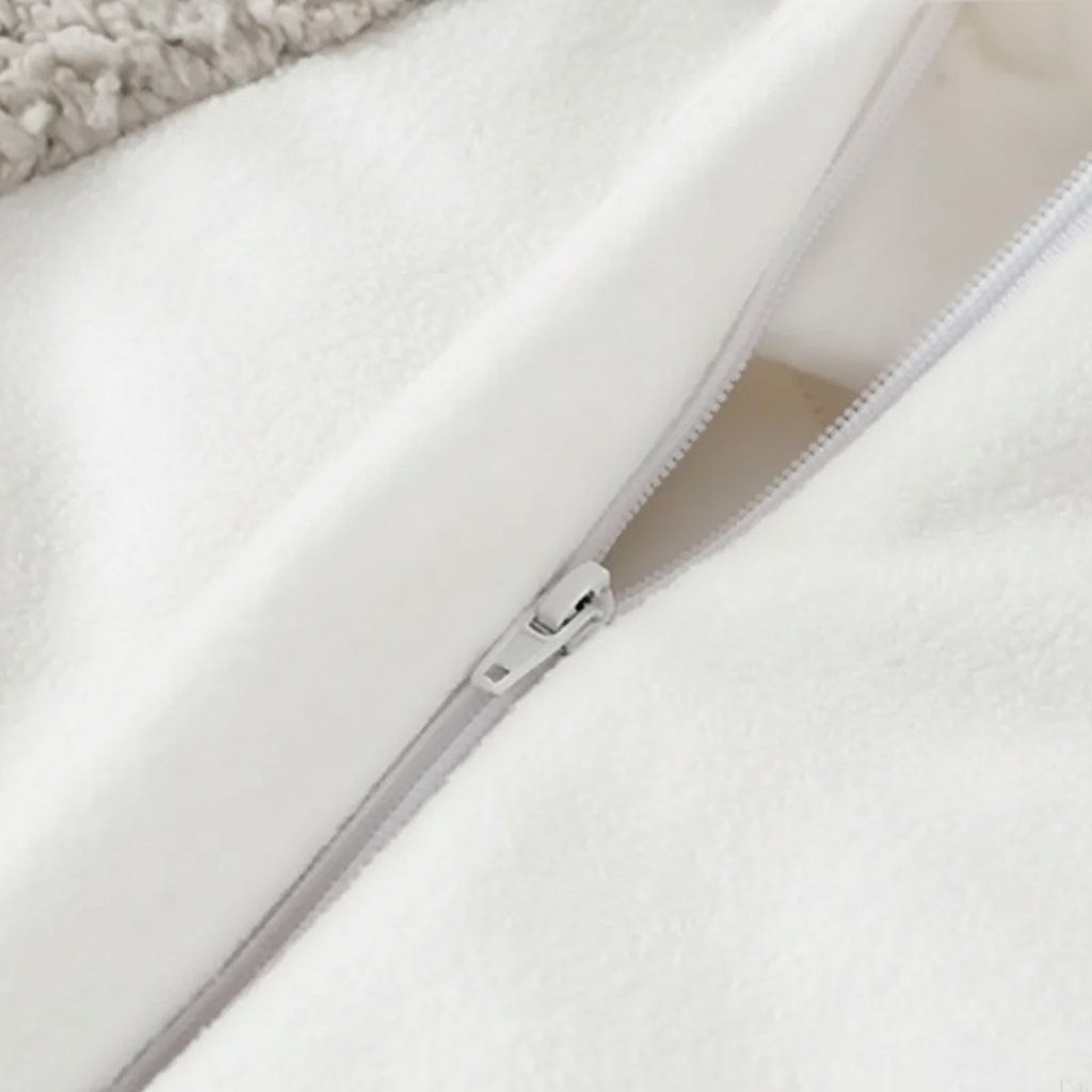 Close-up of the front zipper and white lining on the penguin baby jumpsuit