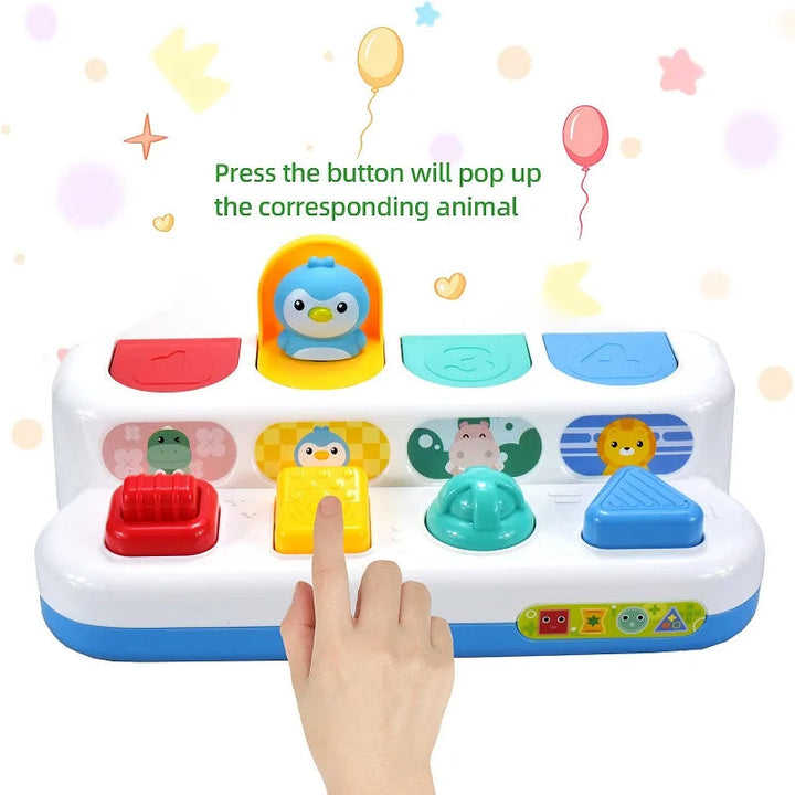Finger pressing the yellow button to open the penguin lid on the animal activity toy