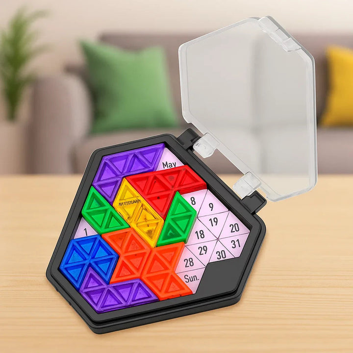 Black pentagon puzzle board with colorful pieces, calendar labels, and an open clear lid