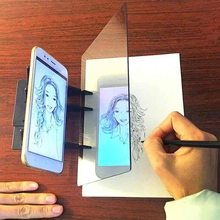 Phone displaying a portrait beside a clear panel while a hand traces on paper