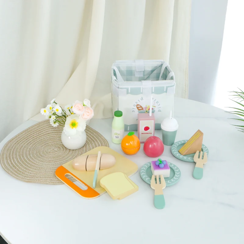 Picnic playset arranged with a carry bag, fruit, bread, plates, and utensils
