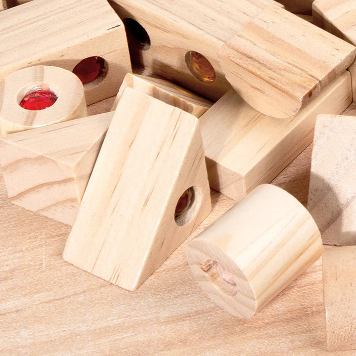 Close-up of pine wood block shapes, visible wood grain, and inset acrylic gems
