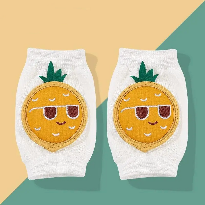 Pair of pineapple-face knee pads with green leaves and white knit sleeves.