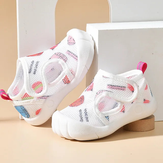 Pink-accented mesh sandals with colorful prints, white soles and closed toes