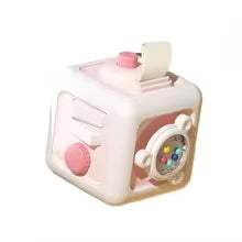 Pink and white activity cube with a top pull tab, turning knob, and bead spinner