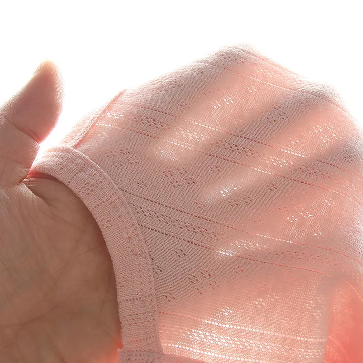 Close-up of lightweight pink cotton knit held over a hand