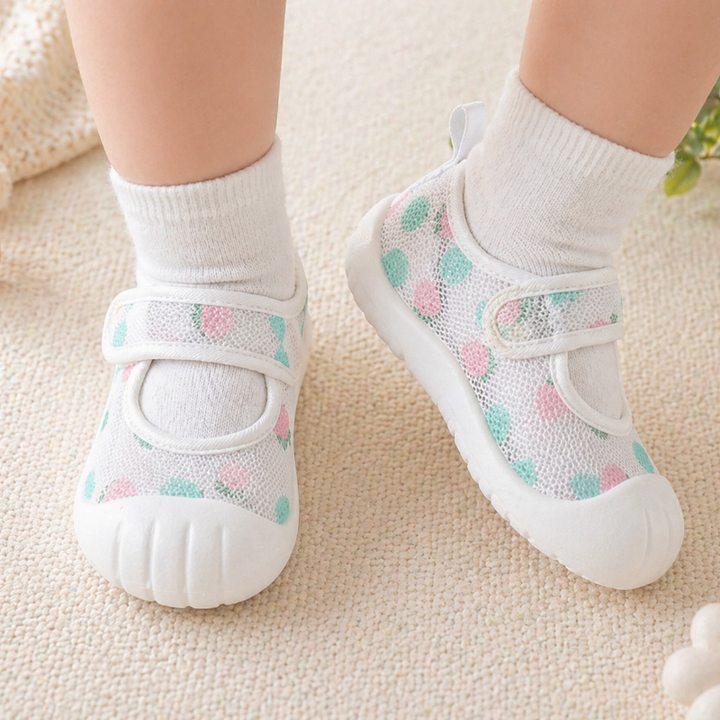Pastel pink and mint patterned strap shoes worn with white socks.