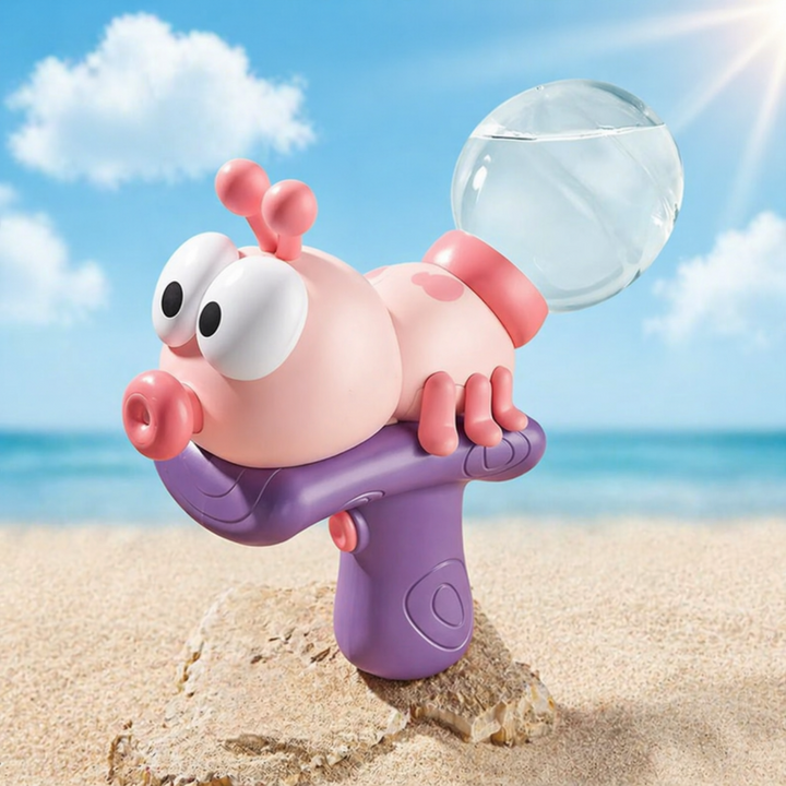 Pink insect-shaped water gun with a purple grip and transparent water reservoir on a beach.