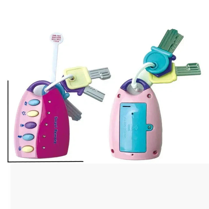 Front and back of the pink baby key toy, showing colorful buttons, attached keys, and battery cover