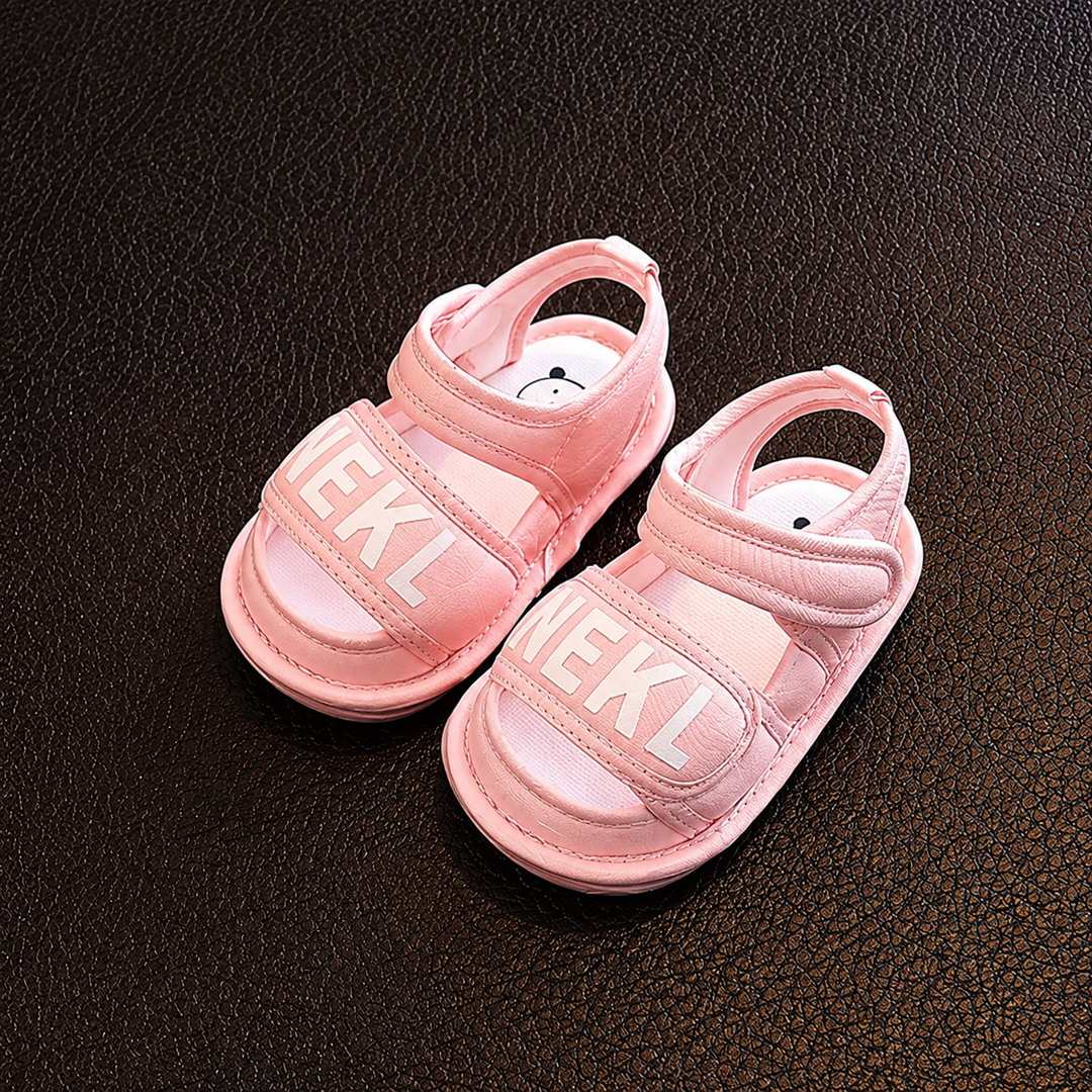 Pair of pink baby sandals with wide front straps and adjustable ankle straps