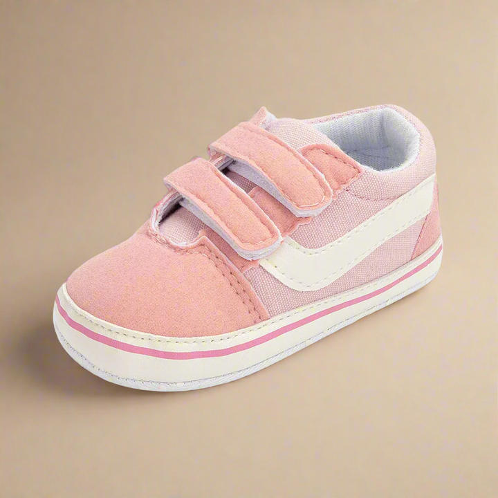 Pink baby sneaker with a white side stripe and hook-and-loop fastening