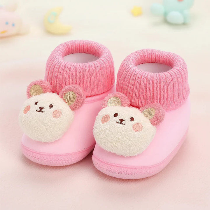 Pink bear baby slippers with plush faces and ribbed ankle collars