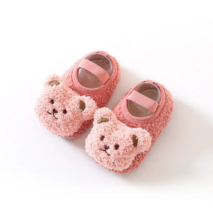Pair of pink baby slippers with pink bear faces and elastic bands
