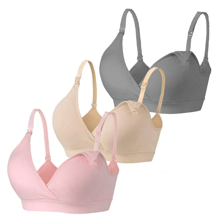 Pink, beige and gray nursing bras shown together with crossover cups and strap clips