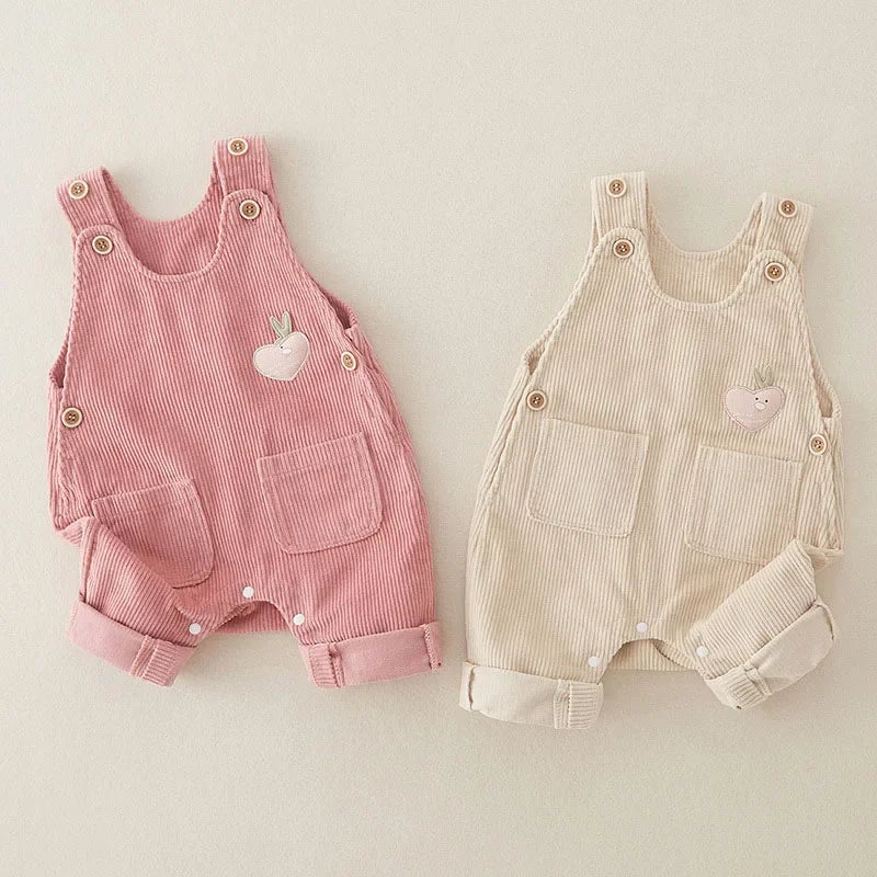 Pink and beige ribbed cotton overalls with buttoned shoulder straps and rolled cuffs