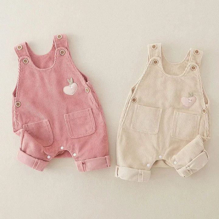 Pink and beige ribbed cotton overalls with buttoned shoulder straps and rolled cuffs