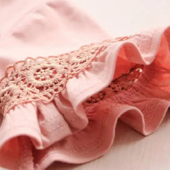 Pink bell sleeve with decorative lace trim and a flared fabric edge