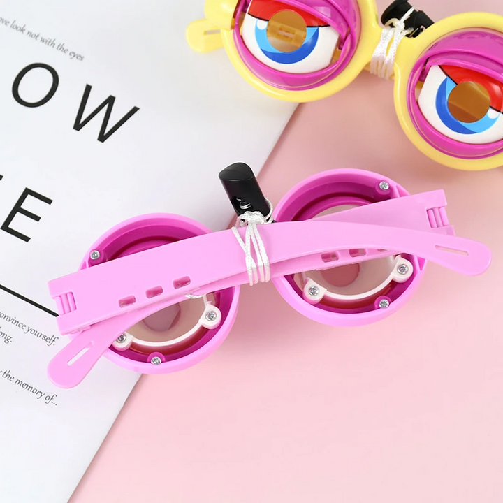 Back of pink toy glasses showing the adjustable arms and white cord