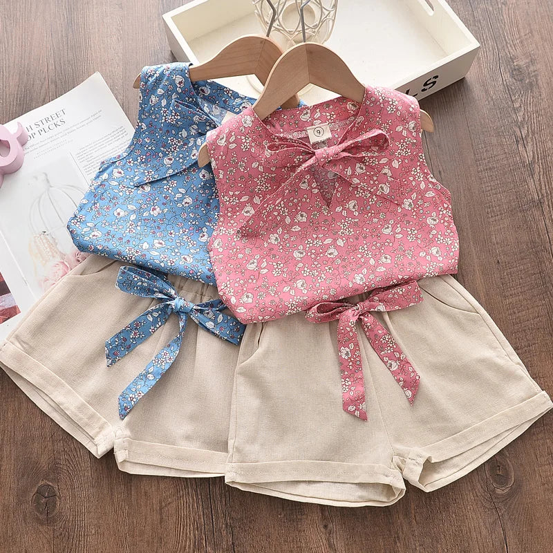 Pink and blue floral two-piece girls' outfits with beige shorts and coordinating waist ties