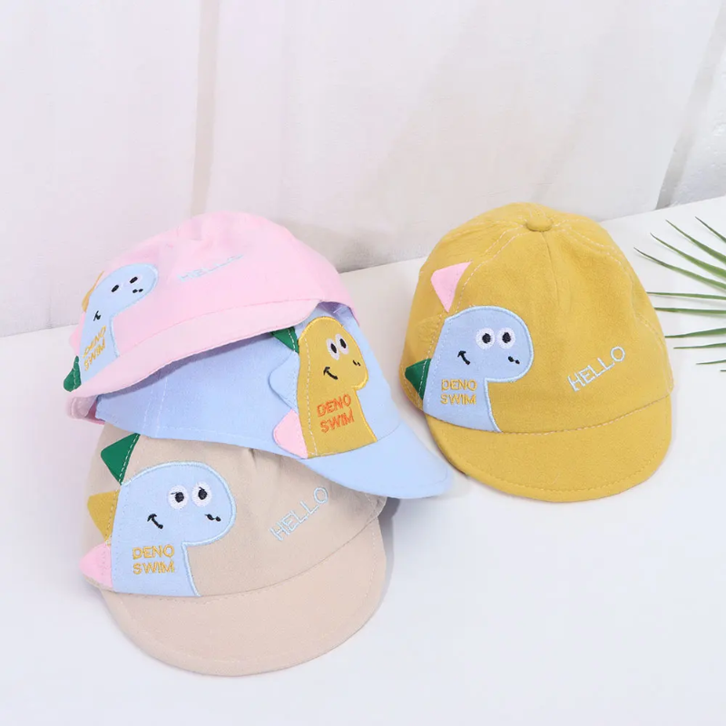 Pink, blue, khaki, and yellow dinosaur caps displayed together.