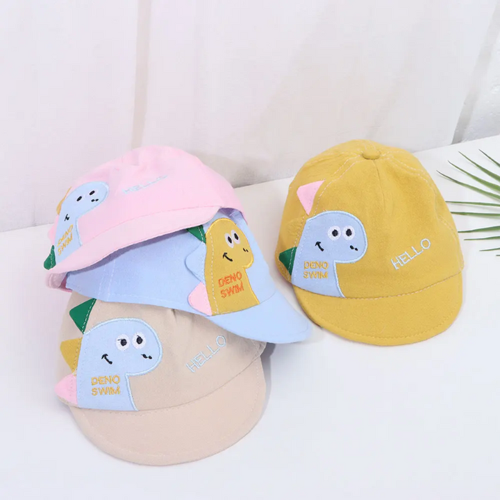 Pink, blue, khaki, and yellow dinosaur caps displayed together.
