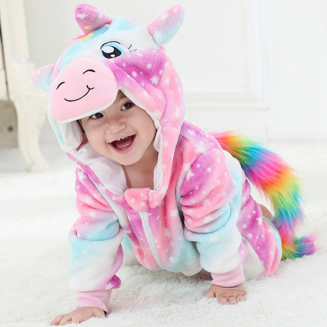 Baby crawling in a pink and blue unicorn onesie with a rainbow tail