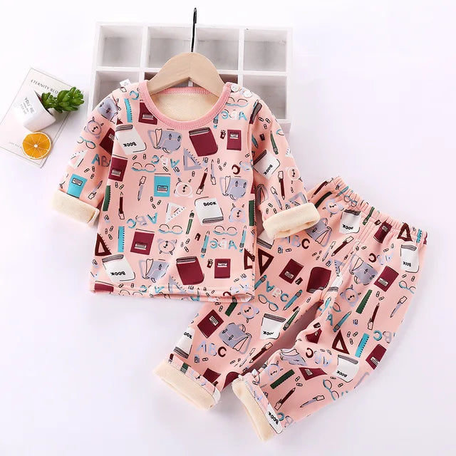 Pink book-print pajama top and matching pants with cream cuffs