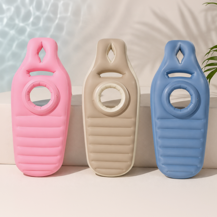 Pink, brown, and blue inflatable pregnancy pillows shown upright with circular belly openings