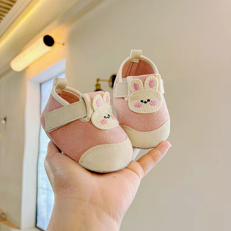 Pink baby shoes with bunny patches, cream toe caps, and hook-and-loop straps