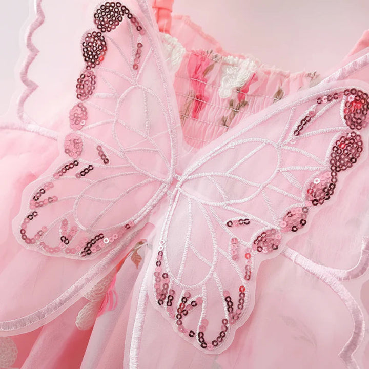 Close-up of sheer pink butterfly wings with embroidered lines and sequin accents