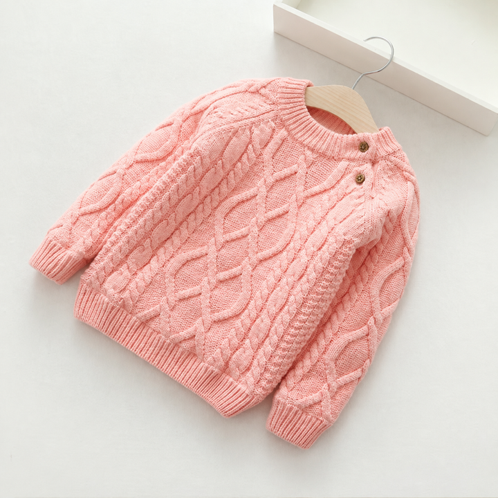 Pink cable-knit sweater with raised cable patterns and ribbed edges.