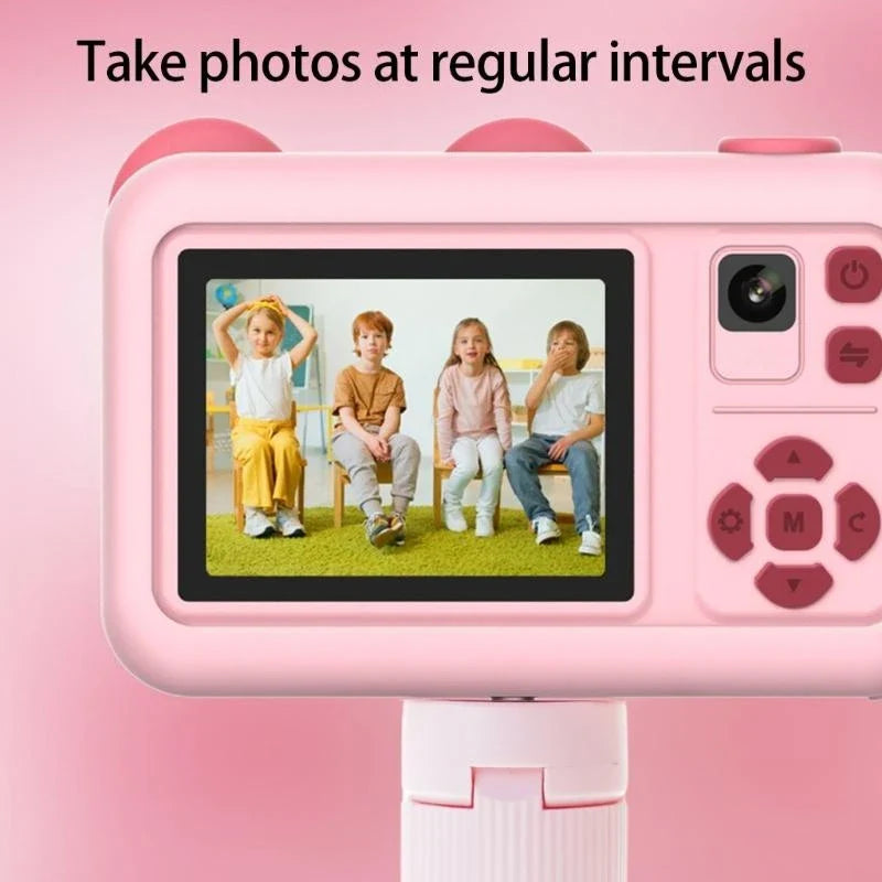 Rear view of the pink camera showing a group portrait on the screen and directional controls