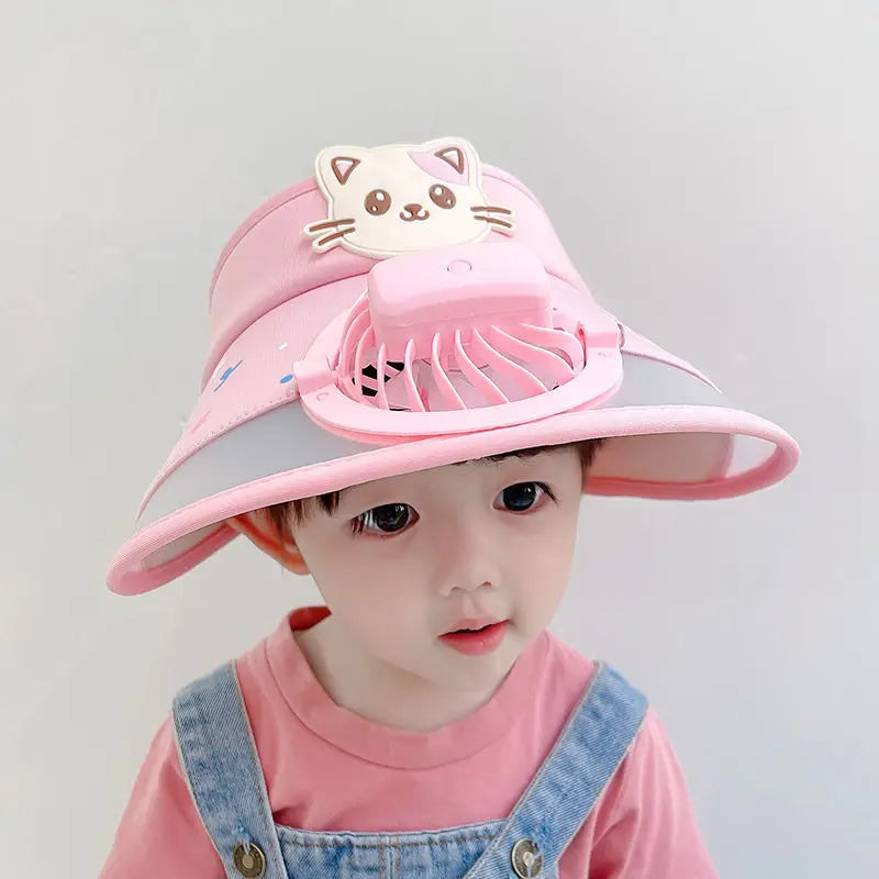 Child wearing a pink fan hat with a cartoon cat decoration
