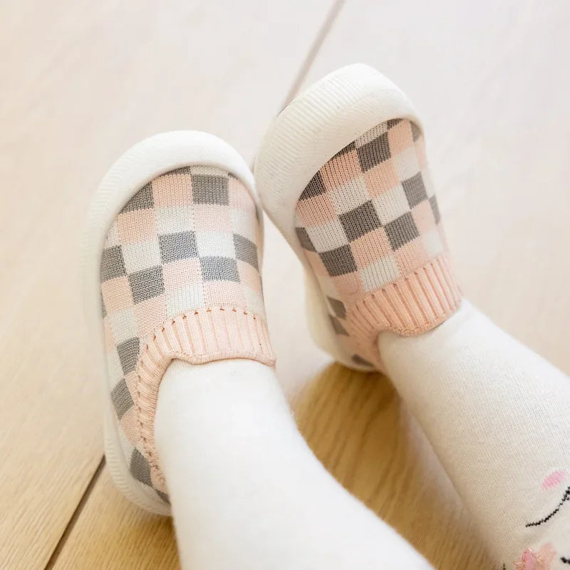 Pink-and-white checkered slip-on shoes worn with white socks