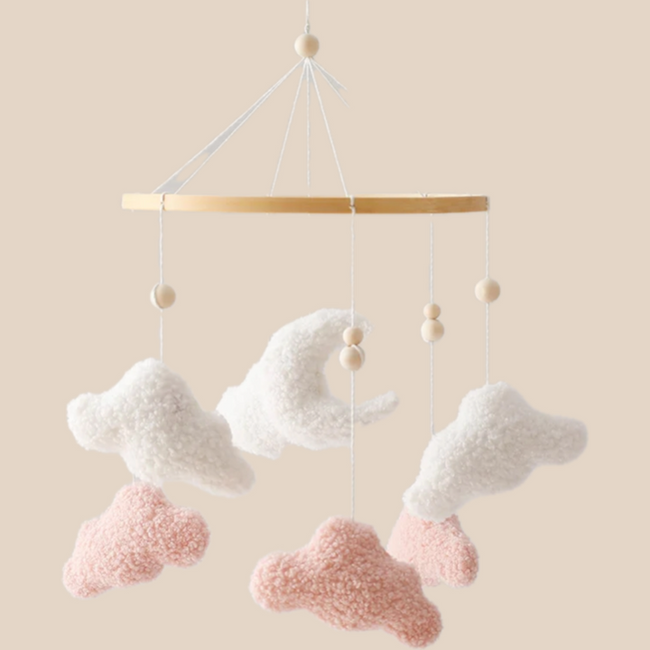 Pink and white cotton cloud mobile with a crescent moon and wooden ring