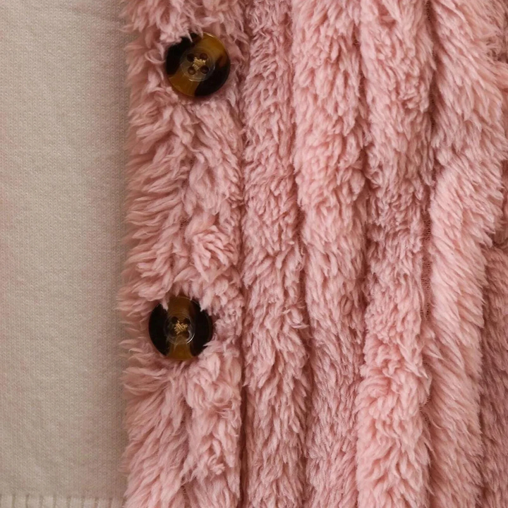 Close-up of brown buttons on the pink coat&