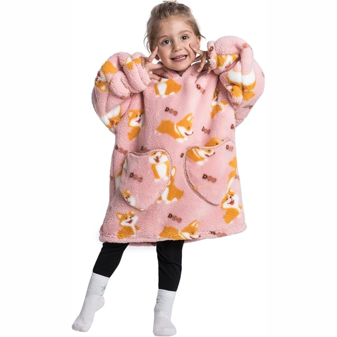 Child wearing a pink corgi-print hooded blanket with roomy sleeves