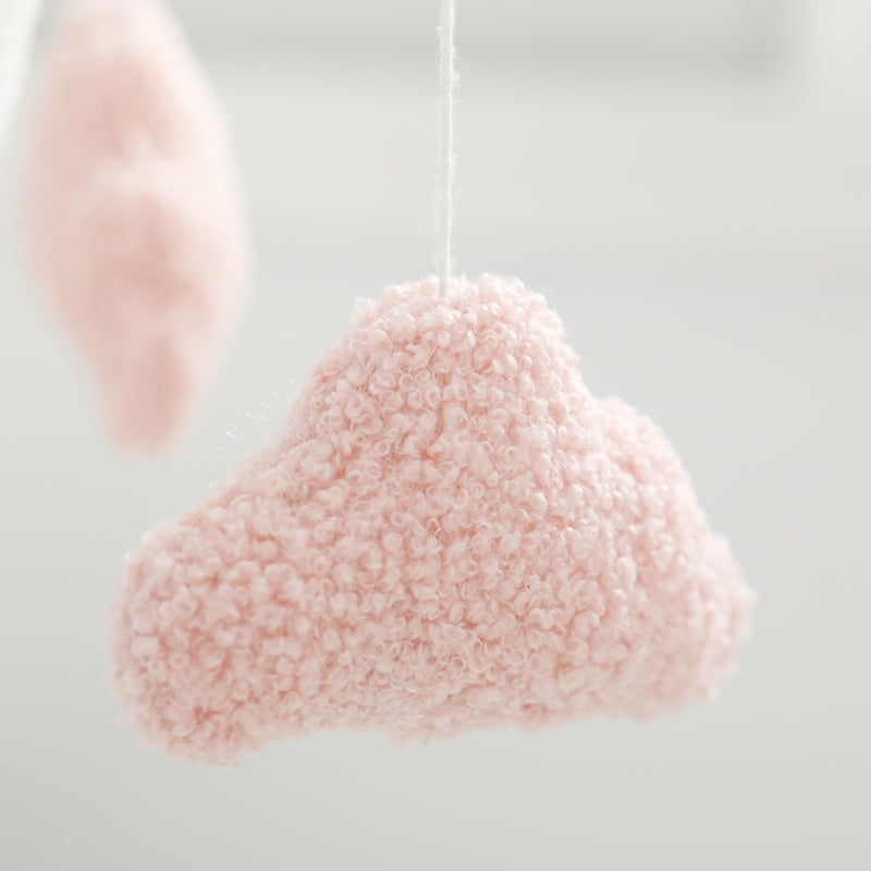 Close-up of a pink cotton cloud hanging from a white cord
