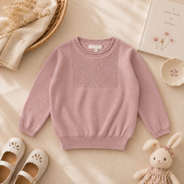Pink cotton pullover with long sleeves and a ribbed chest panel, laid flat
