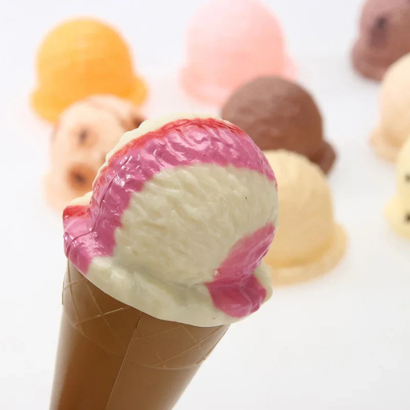 Pink-and-cream swirled ice cream piece resting on a brown toy cone