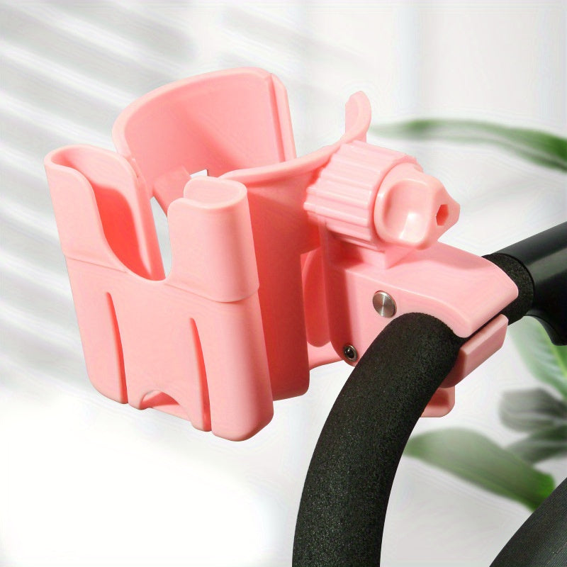 Pink cup and phone holder attached to a black stroller handle.