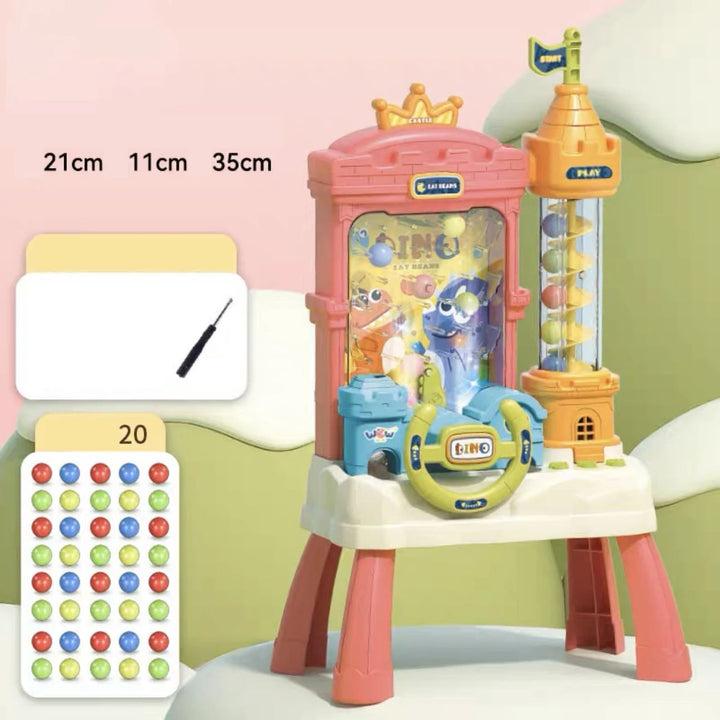 Pink dinosaur arcade toy with dimension labels, a screwdriver graphic and a colorful ball set