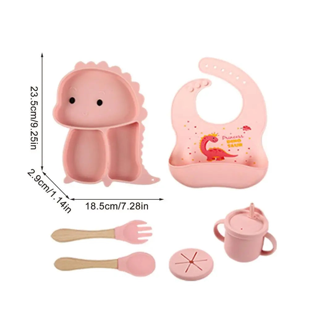 Pink dinosaur tableware set with a plate measurement chart showing 23.5 x 18.5 x 2.9 cm