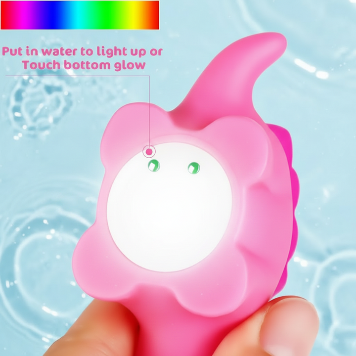 Underside of a pink dinosaur bath toy showing two activation contacts