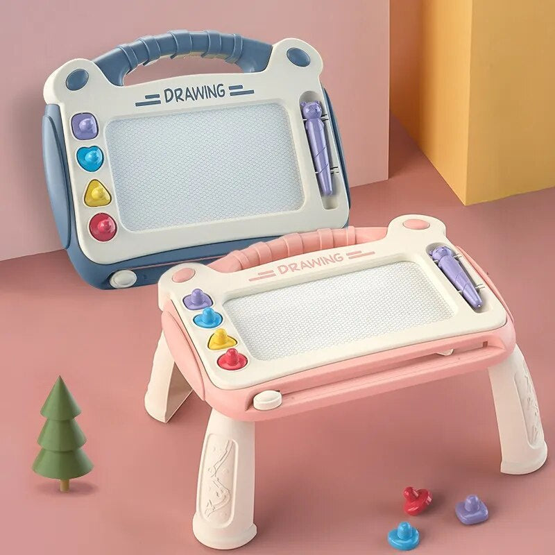 Pink drawing board on four legs beside a blue handheld board, both with built-in handles