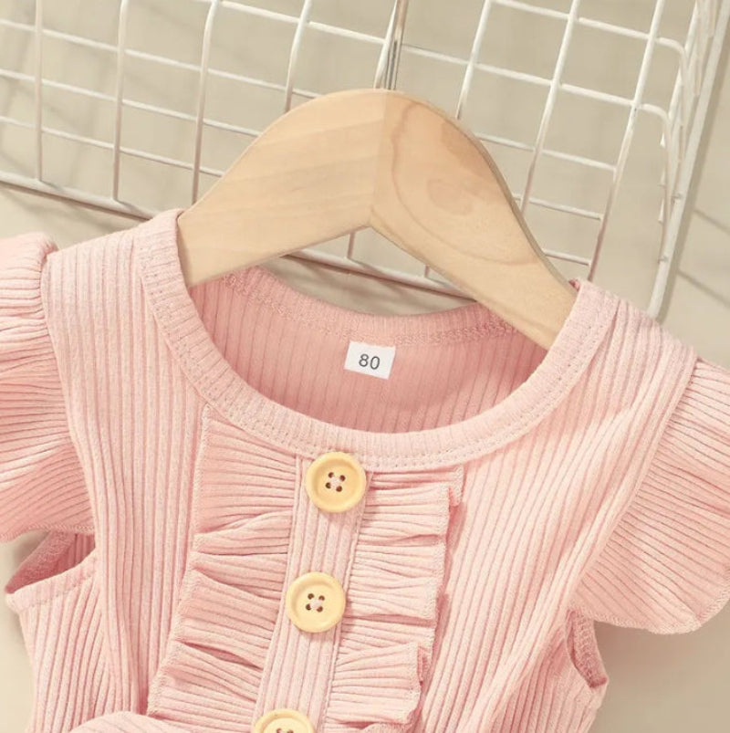 Pink dress neckline with front ruffle trim and decorative wooden buttons