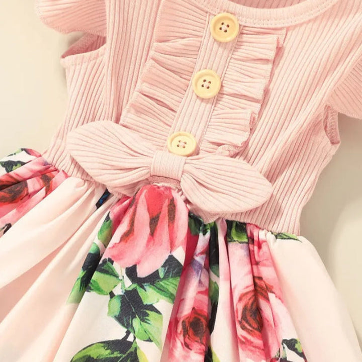 Waist bow, front buttons, and floral skirt on the pink dress