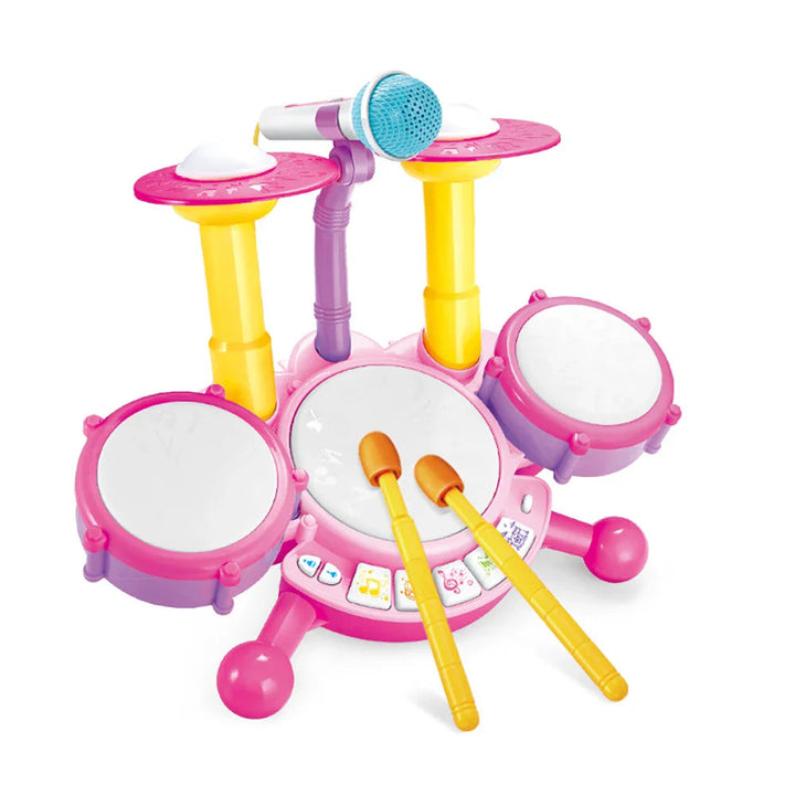 Pink toy drum set with three drum pads, two cymbals, a microphone and two yellow drumsticks