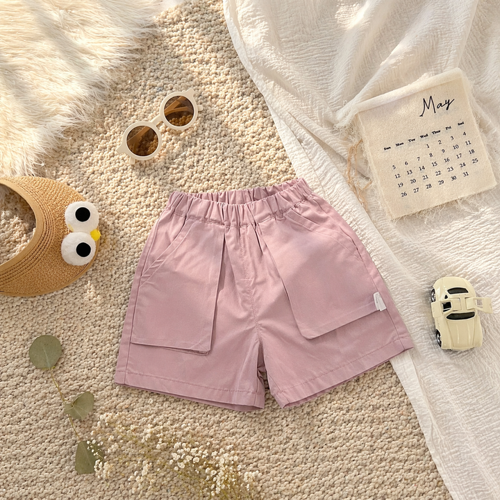 Pink shorts laid flat with an elastic waistband and two large front patch pockets.