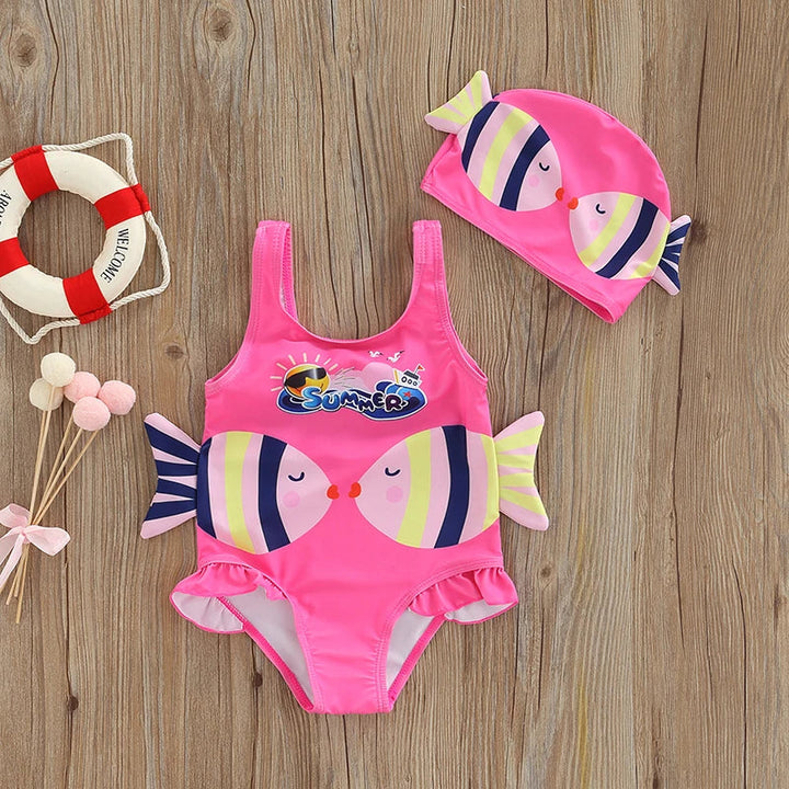 Pink fish-print one-piece swimsuit with ruffled leg openings and a matching swim cap